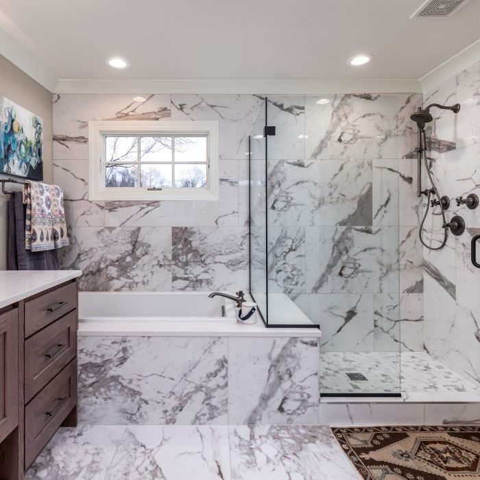 Calacatta Straight Joint Marble-look Porcelain Tile flooring and wall, infusing timeless luxury into your bathroom with its exquisite marble-inspired design.