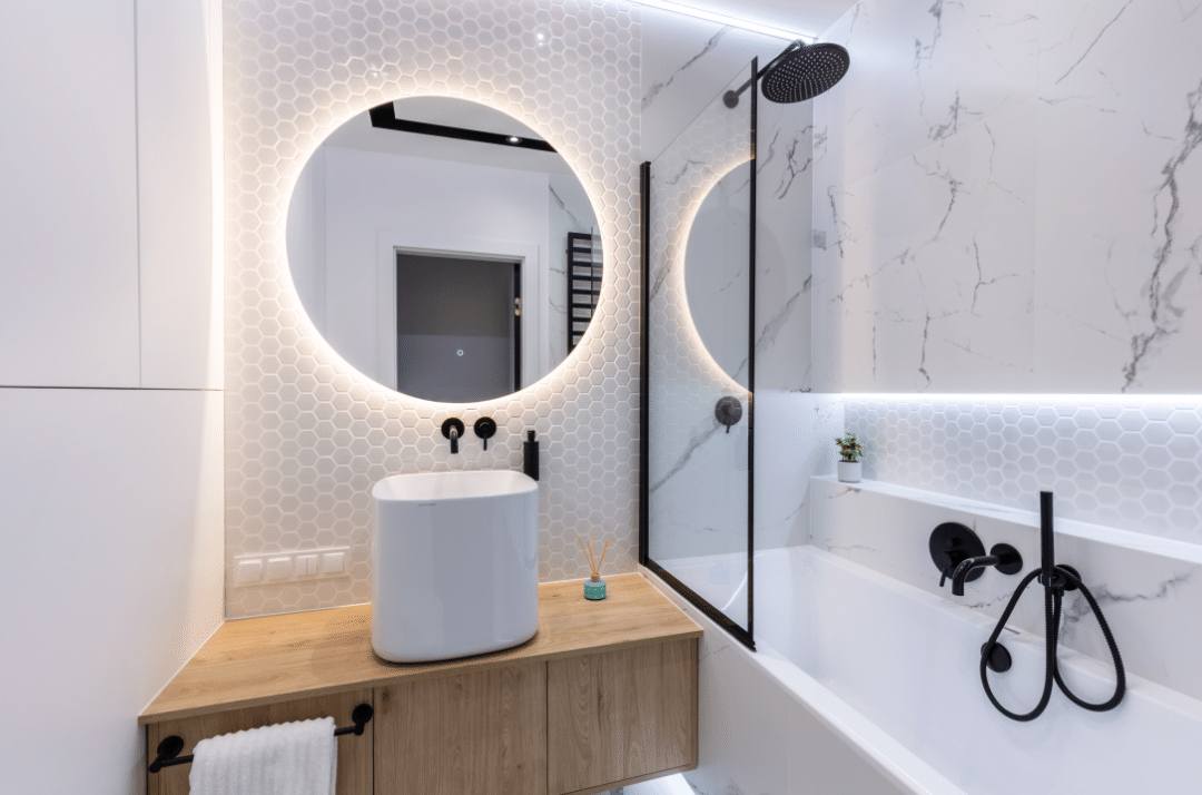 White hexagon mosaic porcelain tiles with white grout on a small bathroom wall