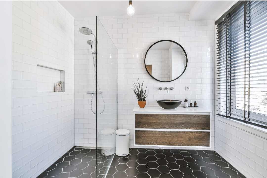 A small bathroom with white subway wall tiles and black hexagon floor tiles These sizes impact the appeal of your inner sanctum.