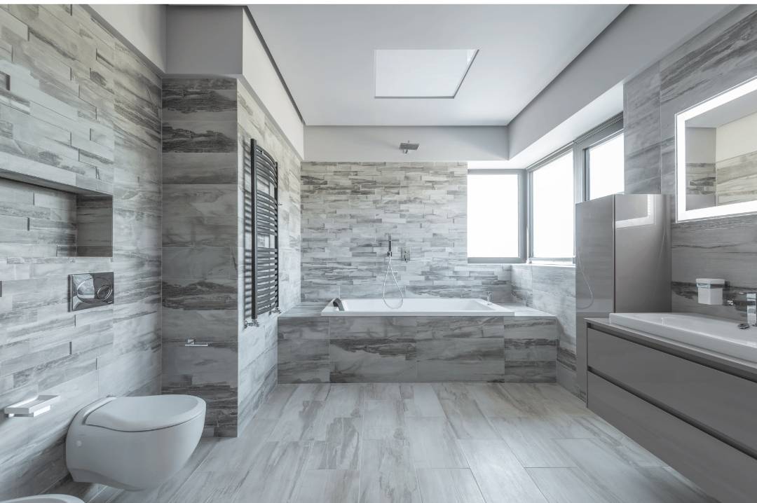 A modern bathroom with Ash plank French or Versailles floor and wall tile patterns