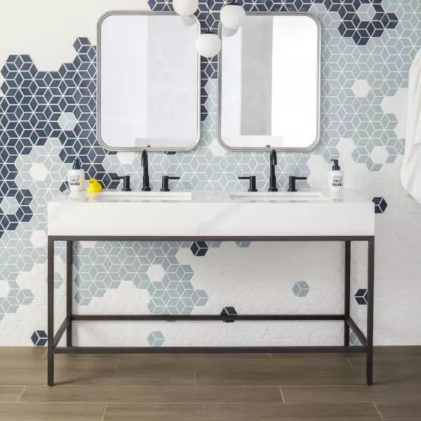 12x12 Ash White Plank Porcelain Tile - A modern bathroom with brown wood-look floor tiles and a wall decorated with mosaic tiles in navy blue, white, and gray, featuring a shower area made of 12x12 Ash White Plank porcelain tiles from the Color Wheel Retr