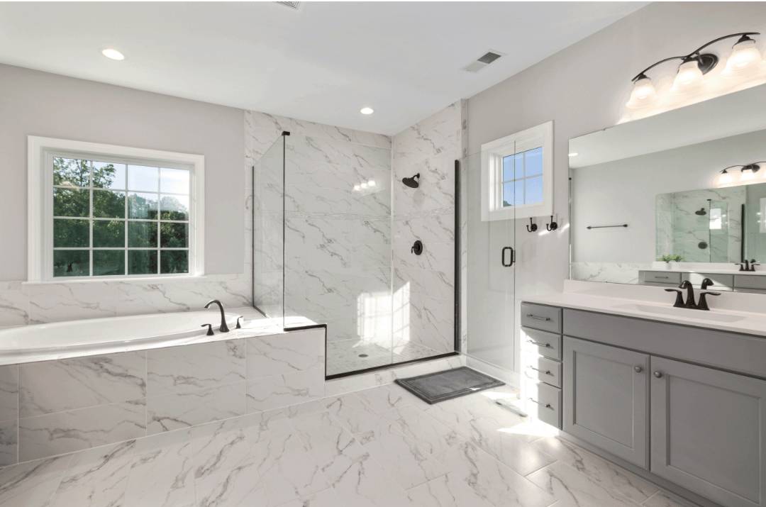 an all-white bathroom with marble-look porcelain tiles