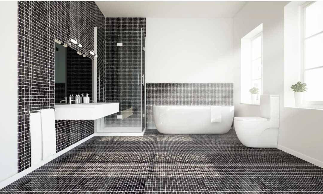 A spacious bathroom with white walls and black and white ombre mosaic tiles