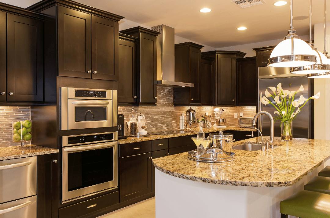 A classic kitchen design with gold interlocking glass backsplash tiles and black cabinets