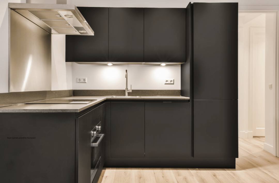 Beige backsplash tiles blend well with black kitchen cabinets 