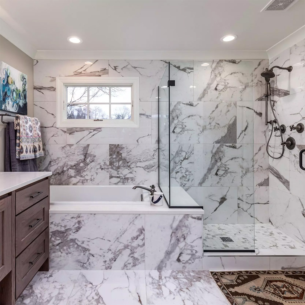 Calacatta Straight Joint: White marble-look porcelain tiles on a shower wall and floor