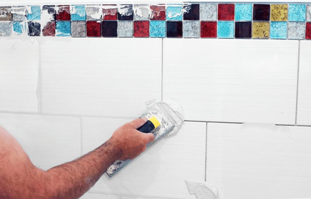 Applying white grout on white ceramic tiles