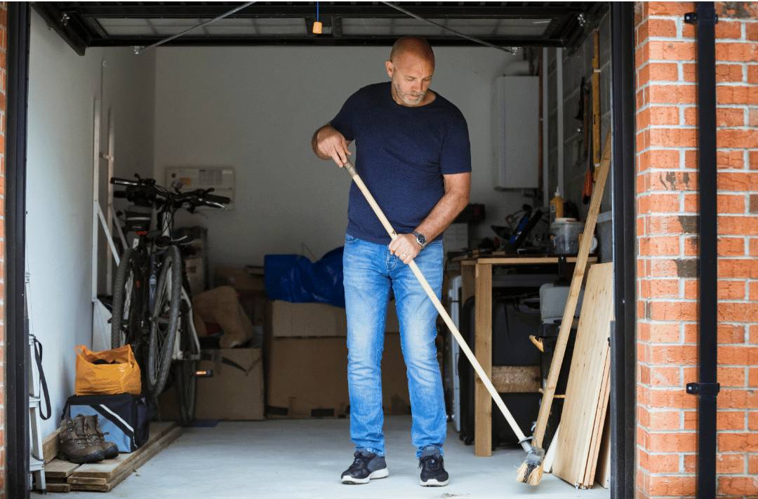 Man cleaning his garage floors