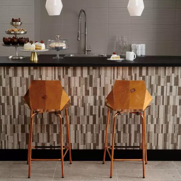 A modern kitchen featuring a sleek backsplash of large rectangular tiles resembling concrete. These 24x48 Natural Grey Rectangle Concrete-look porcelain tiles create a stunning contrast with the beige and brown countertop trims.