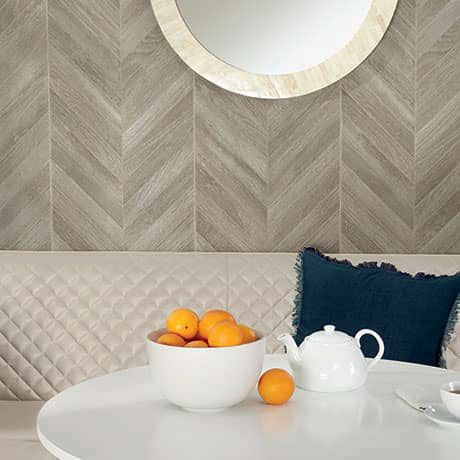 Wood-look brown chevron tiles on a small living room wall