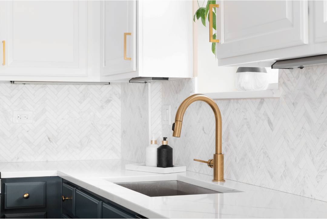 White herringbone subway tiles on a modern kitchen backsplash