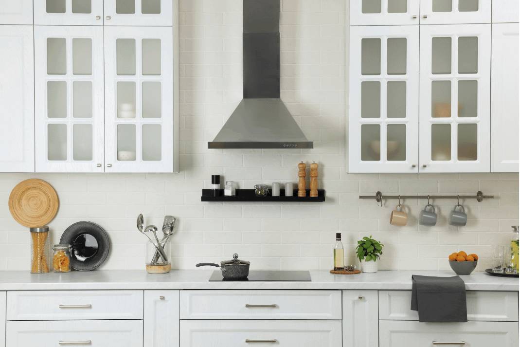 White travertine backsplash blending seamlessly with white kitchen cabinets