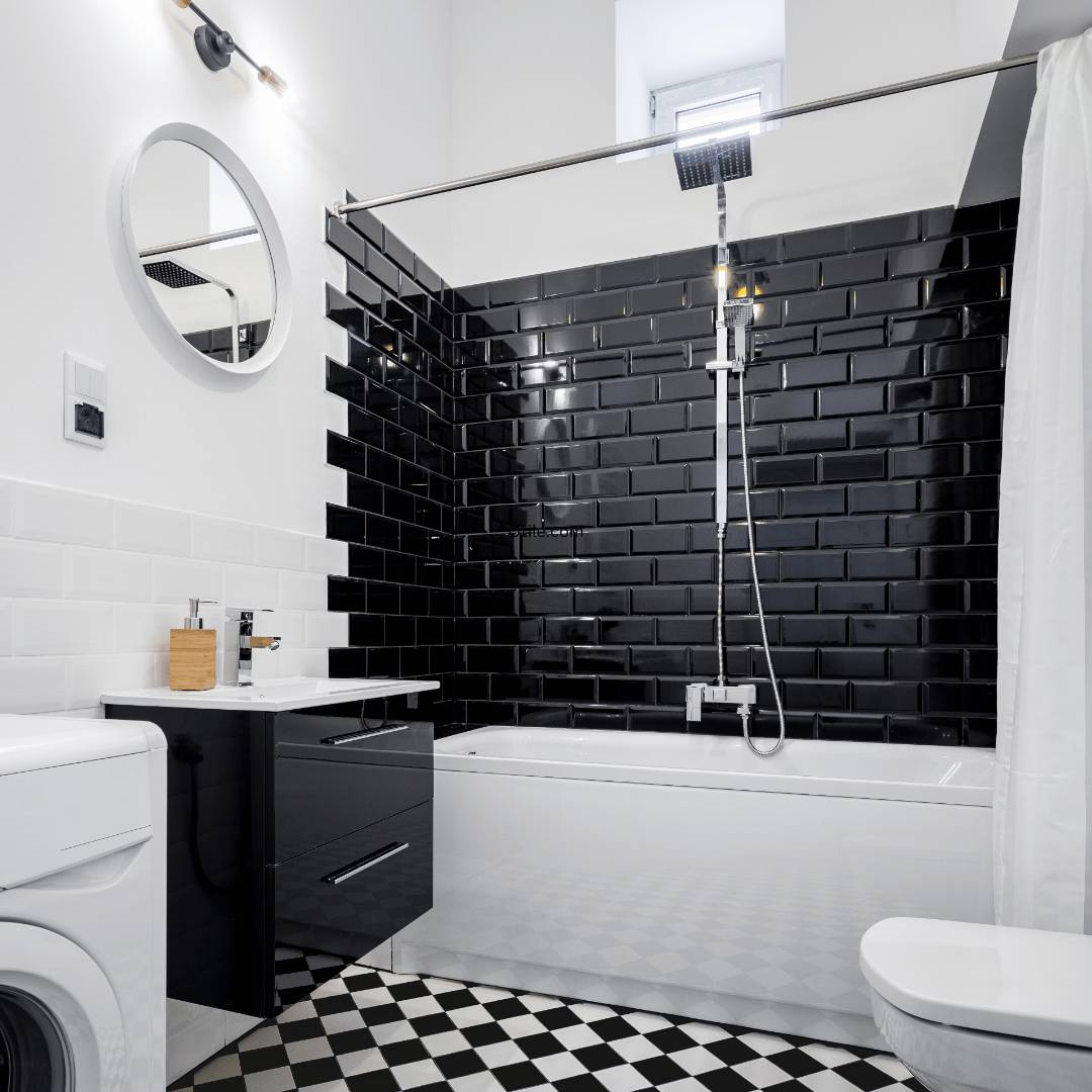 Bathroom wall with black and white subway tiles and a checkered floor.