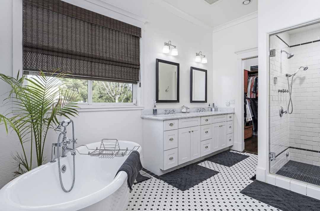 a contemporary bathroom with black and white hexagon floor tiles