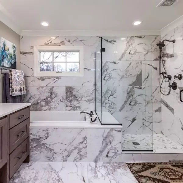 Calacatta Straight Joint White Marble-look Porcelain Tile - A chic and refined bathroom with walls and floors that showcase the Calacatta Straight Joint porcelain tiles that imitate white matte marble, giving a sense of grace and elegance