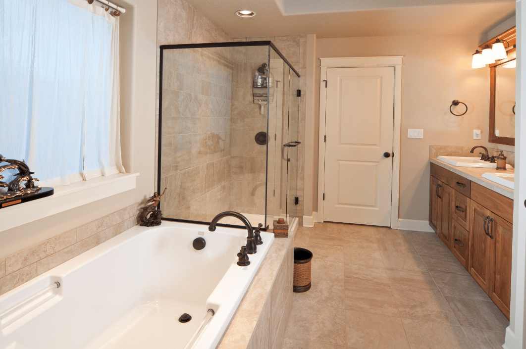 Spacious bathroom with enclosed shower and travertine walls and floors
