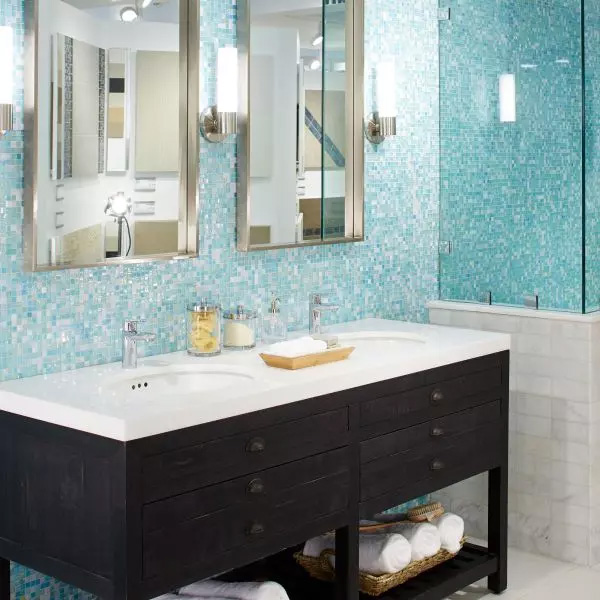A bathroom wall with Daltile&rsquo;s South Beach Straight Joint green glass tiles from the City Lights collection.