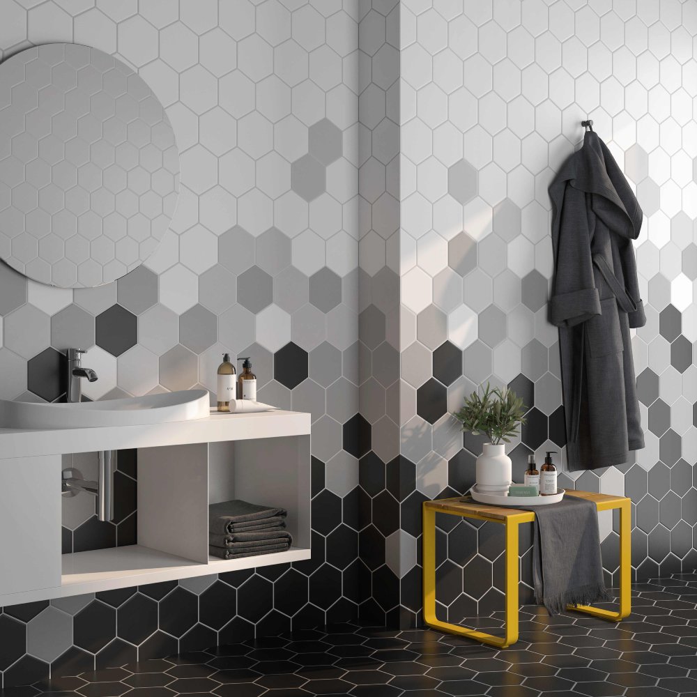 An image of a bathroom using an accent wall with gray and black hexagon tiles