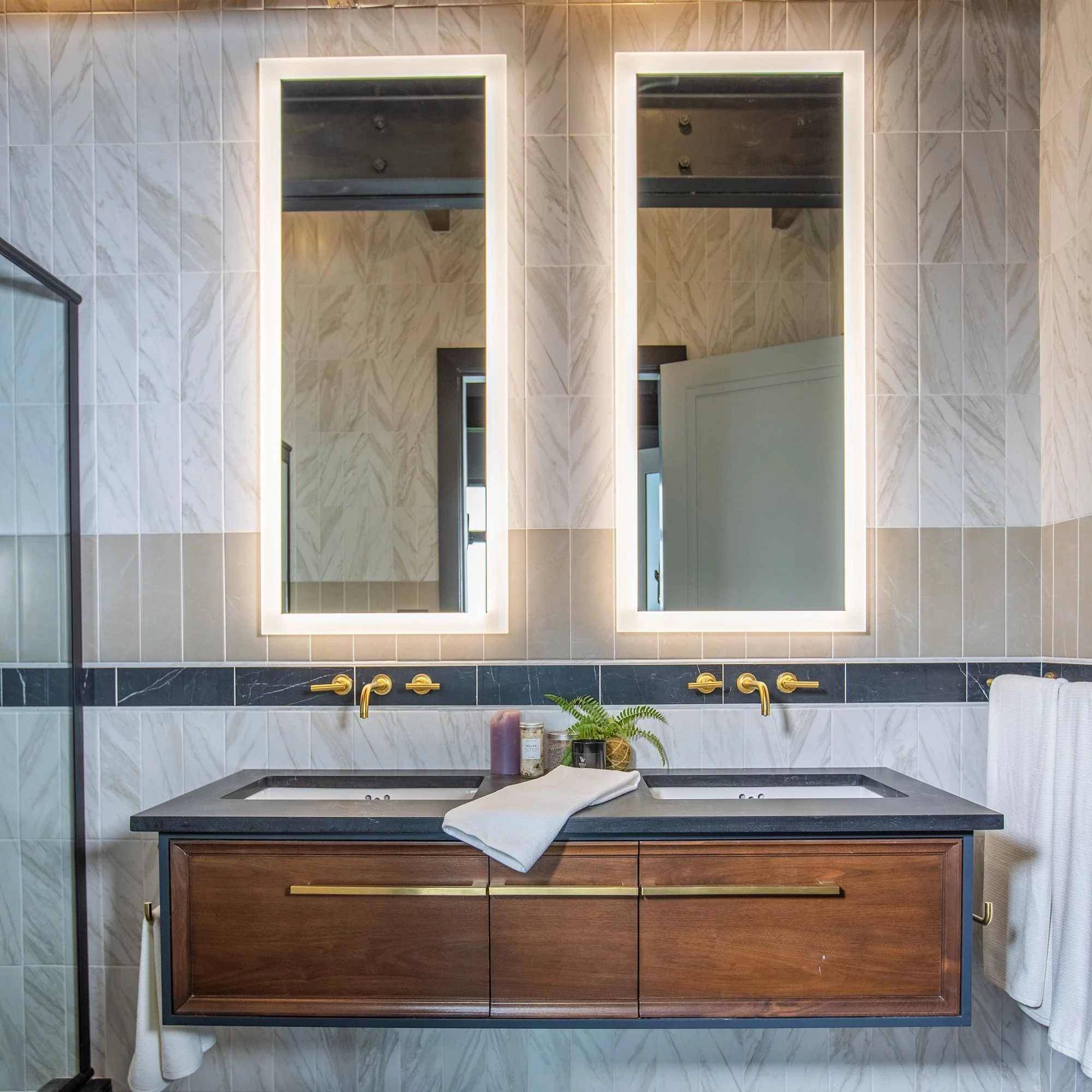Bathroom with vertical subway wall tiles a floating sink and cabinet